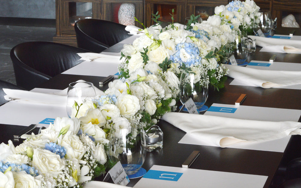 flowers in white and blue table arrangement