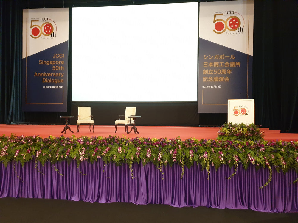 stage decoration with flowers and curtain at NUS